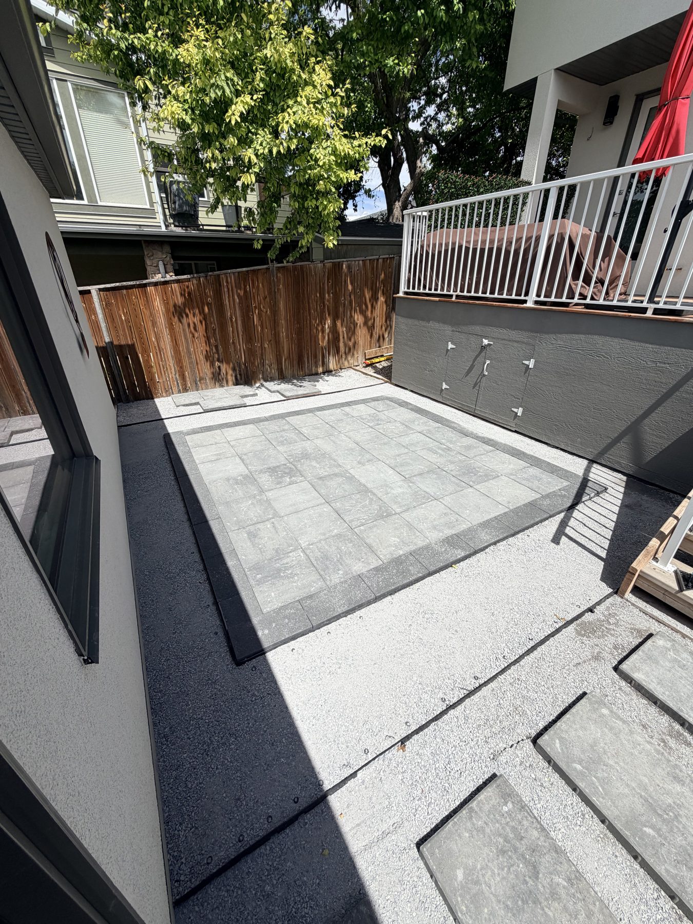 Patio area with gray pavers and white gravel surround — 3505 41 Street SW, Calgary
