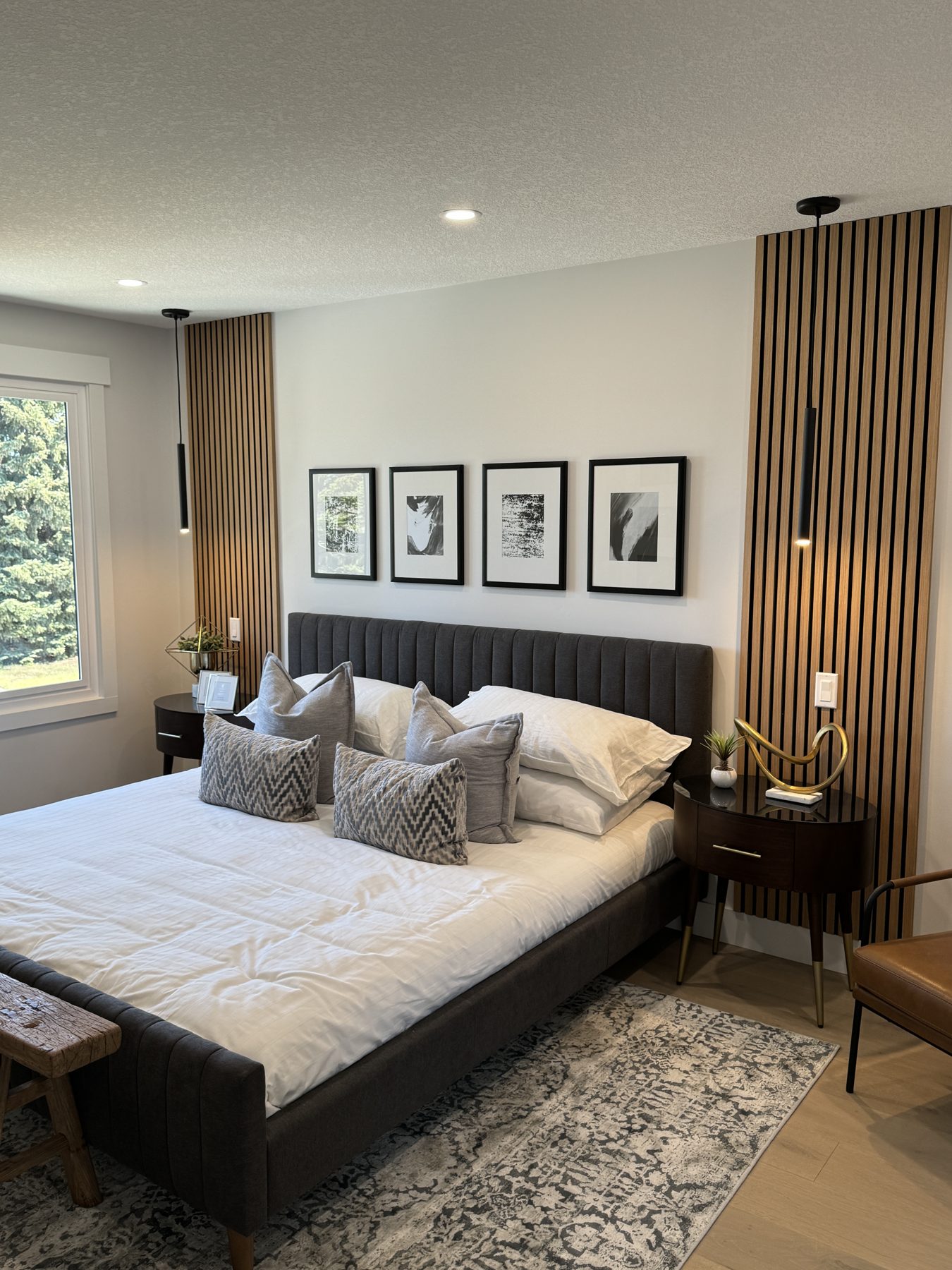 Modern bedroom with slatted wood accent walls and artwork — Lake Bonavista