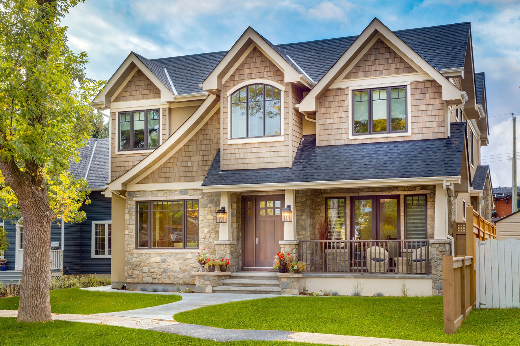 New house exterior with stone and wood siding, completed — Artista by Onsite Contracting Services