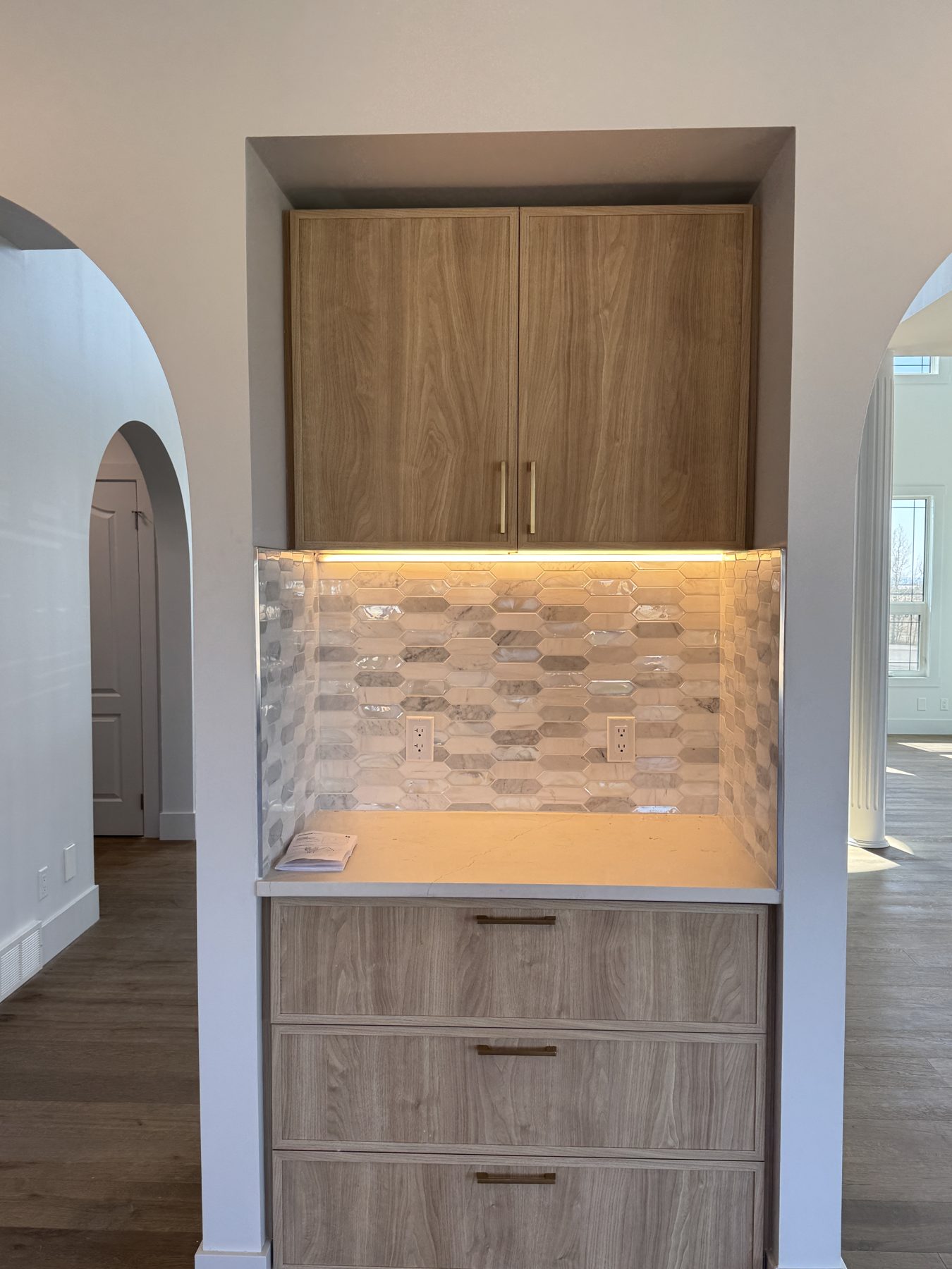 Newly installed wood cabinets and modern hexagon tile backsplash with under-cabinet lighting — 14 Lochend Drive, Cochrane