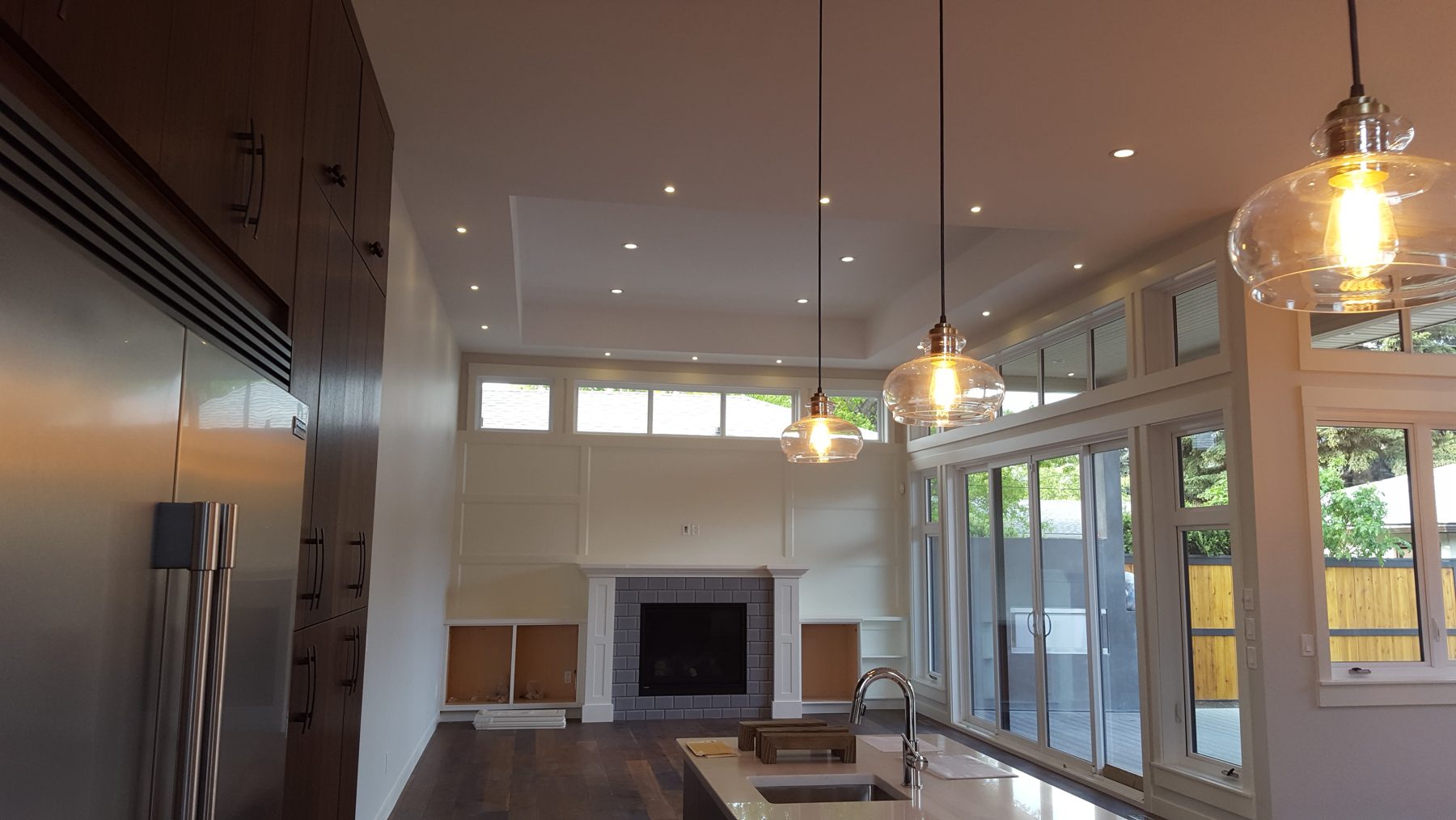 Modern kitchen and living area renovation with fireplace and large windows — Briar Hill