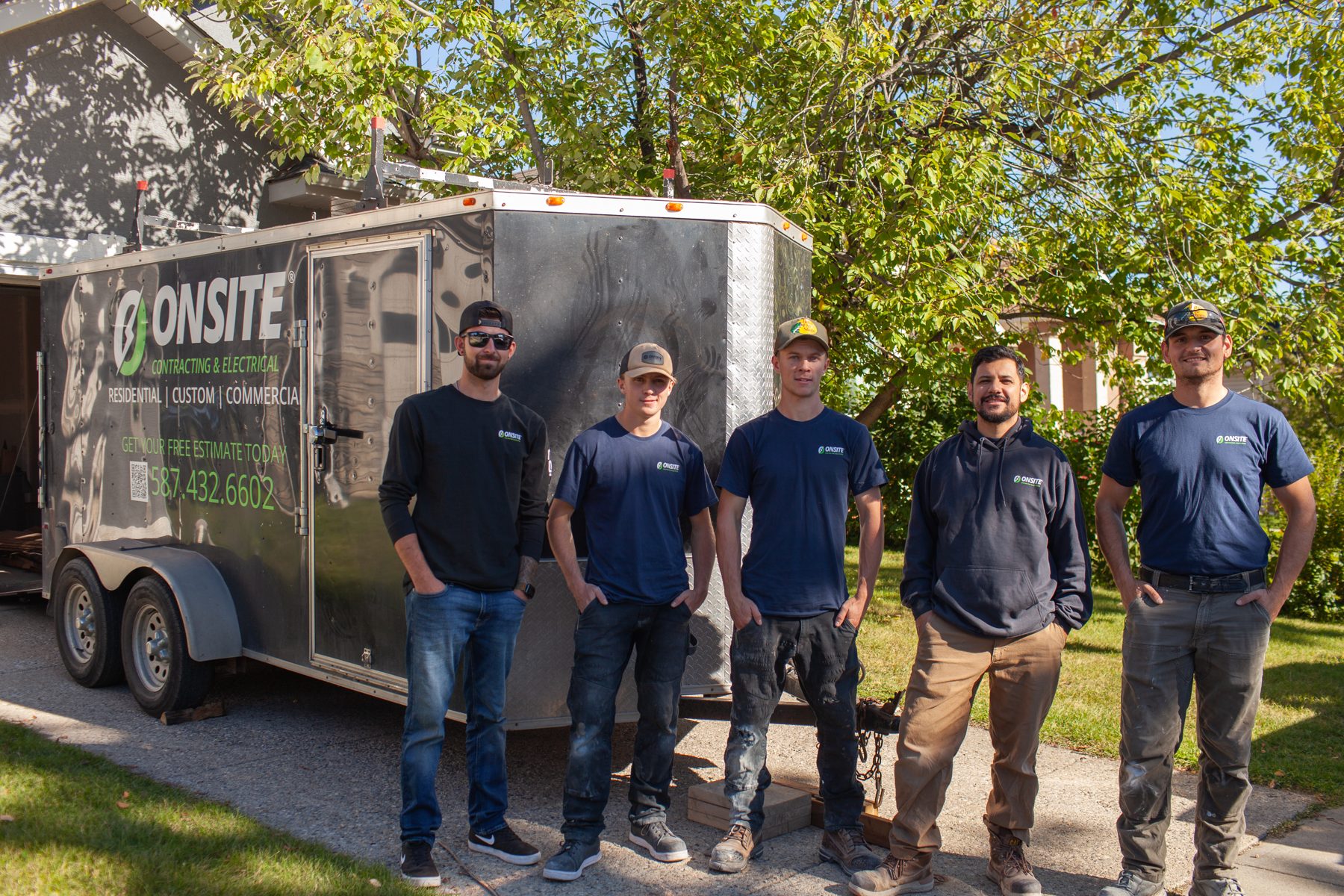 Construction crew stands by their branded trailer during an outdoor project — 32 Somercrest Manor SW