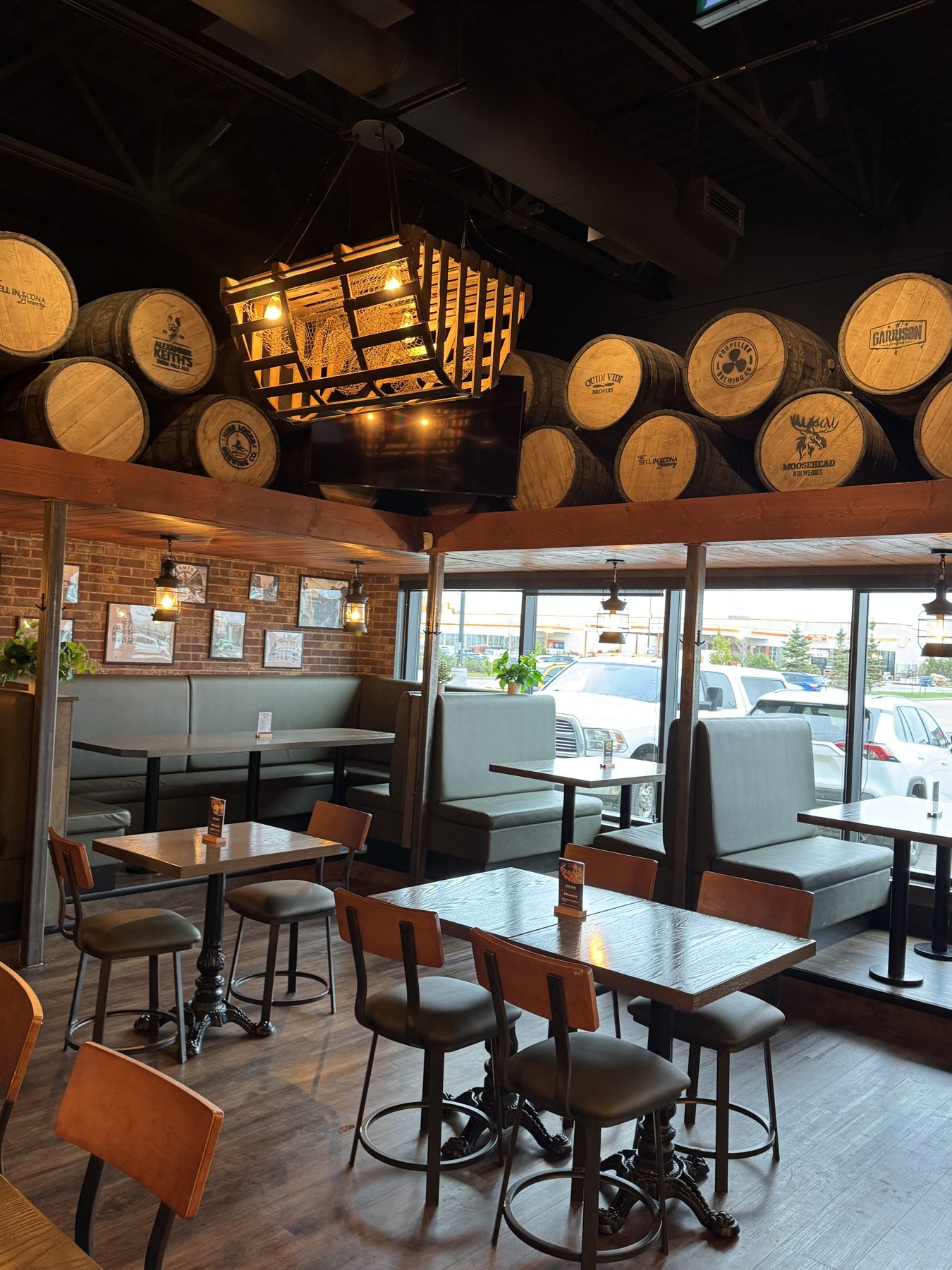 Restaurant dining area with barrel decor, booths, tables, and chairs — Blowers and Grafton (Lloydminster)