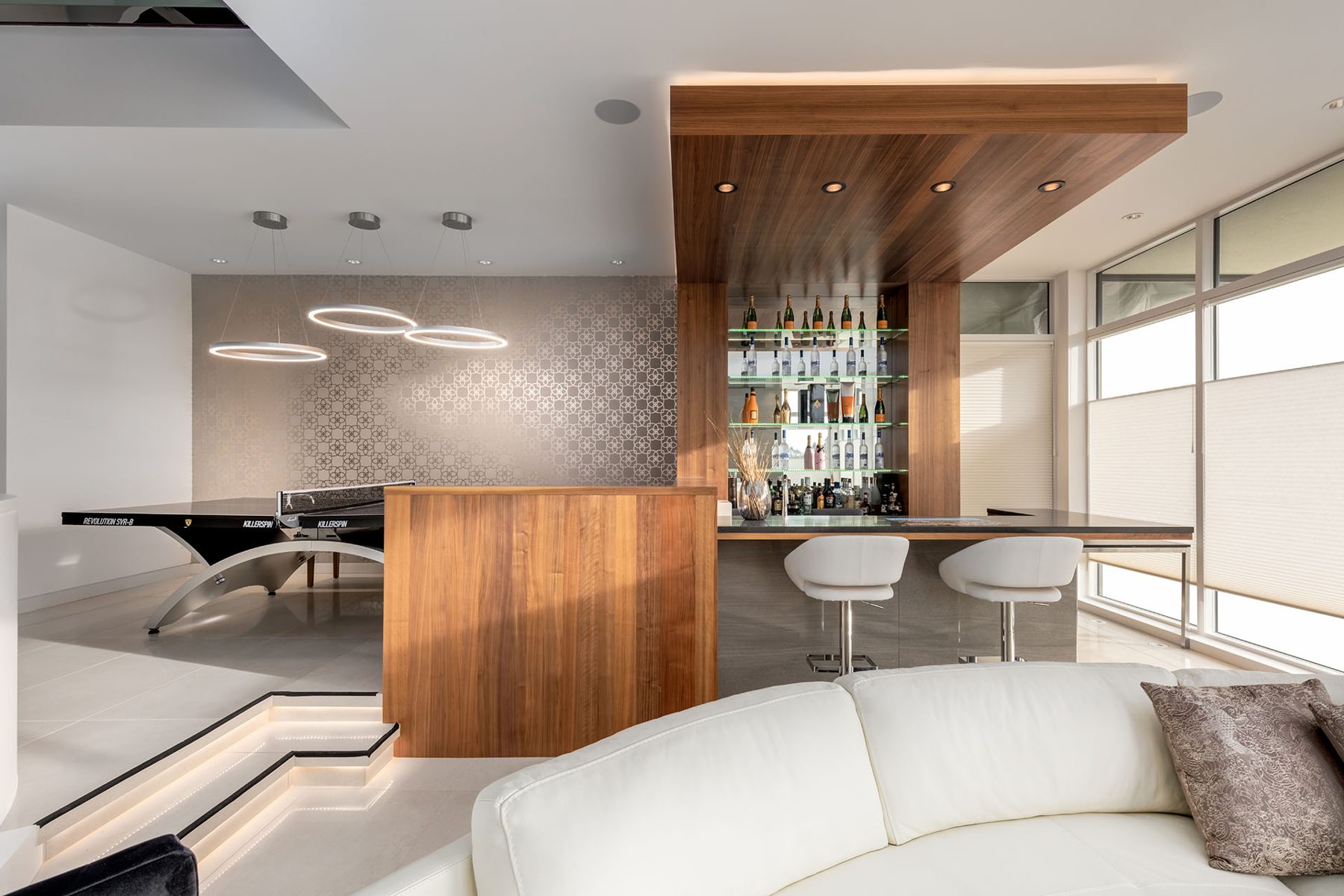 Modern bar area with ping pong table and tiered lighting — Timeless Form