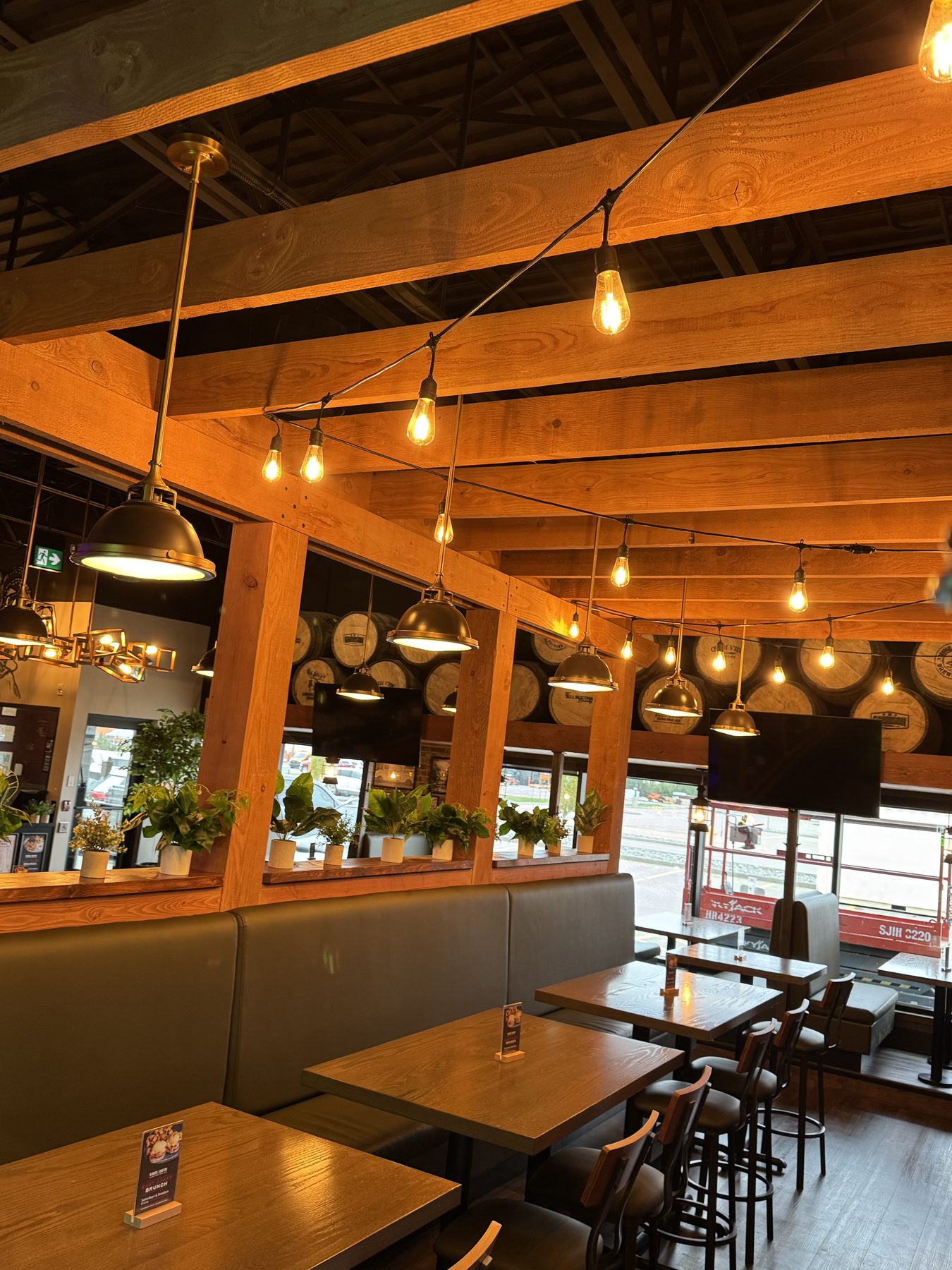 Restaurant dining area with wood beams, pendant lights, and booths — Blowers and Grafton (Lloydminster)