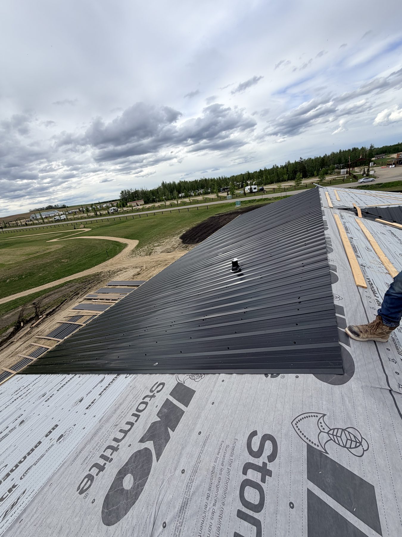 Roofing underlayment and dark metal panels installed on new construction — Sandy Point (Club House)