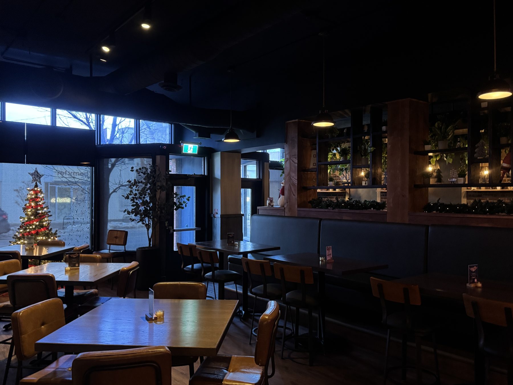 Modern restaurant interior with dark tables, leather chairs, and festive decor — Blowers and Grafton (Mission)