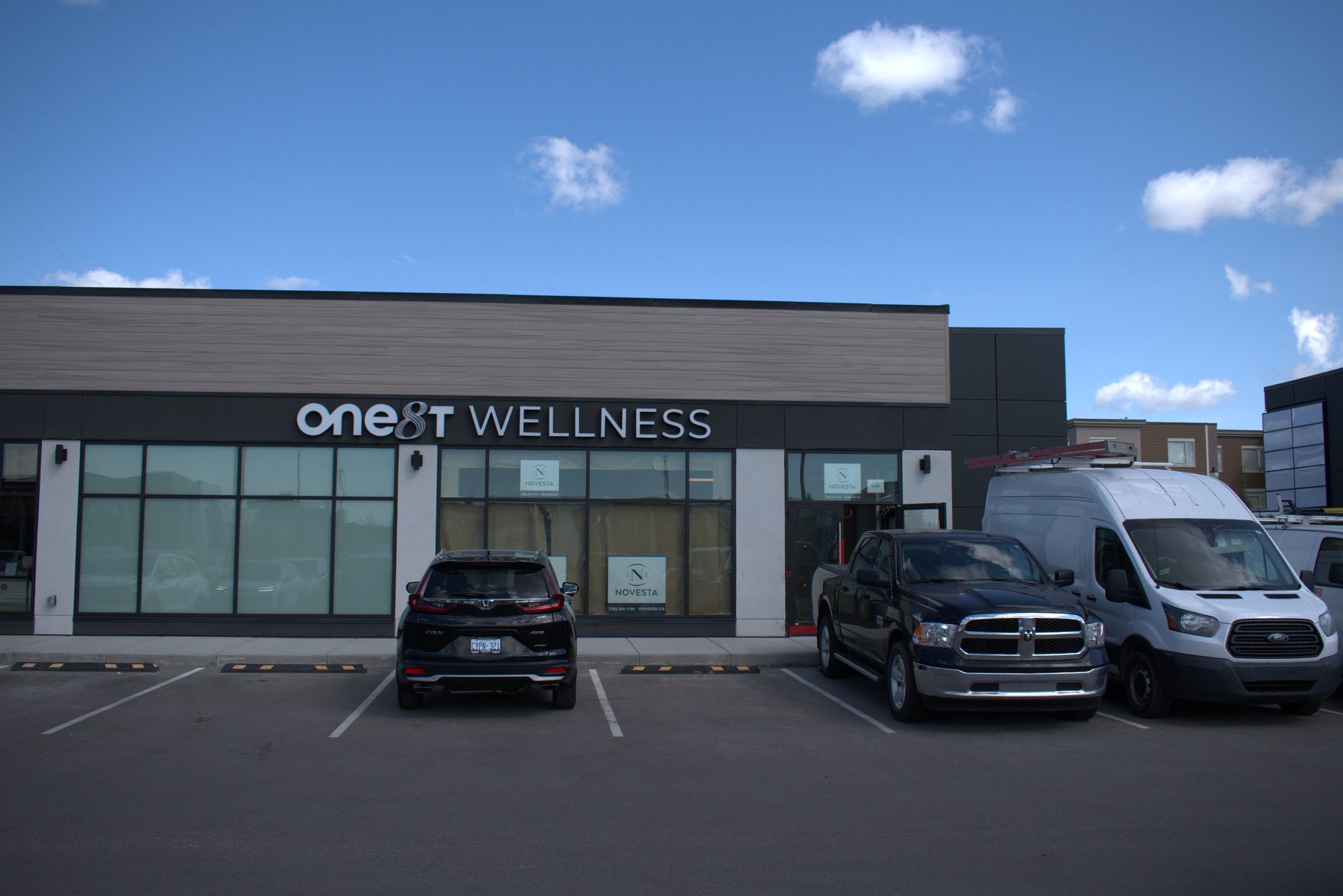 Exterior of building under renovation with "One8T Wellness" signage — ONE8T (West District)