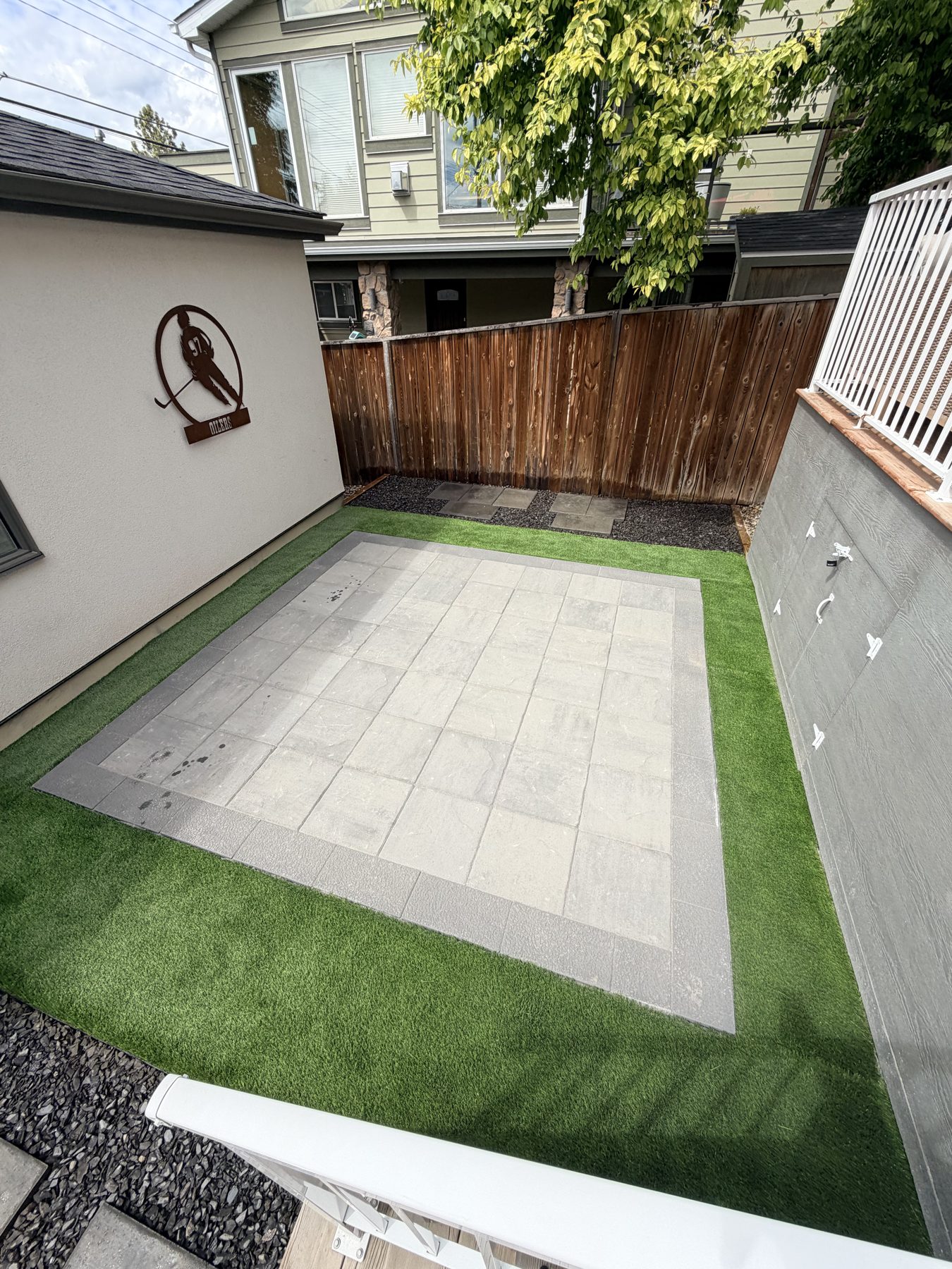 Patio with paver tiles, artificial turf, and gravel landscaping — 3505 41 Street SW, Calgary