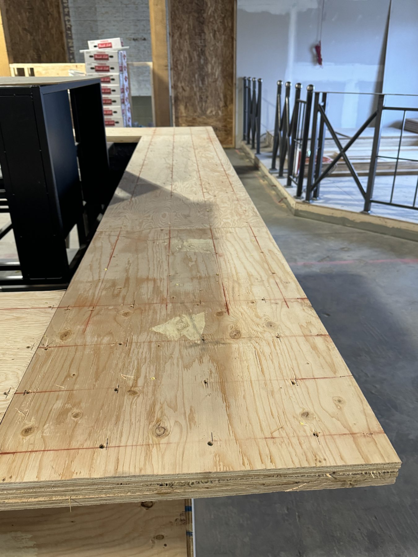 Plywood countertop base with red grid lines and construction in progress — Blowers and Grafton (Medicine Hat)