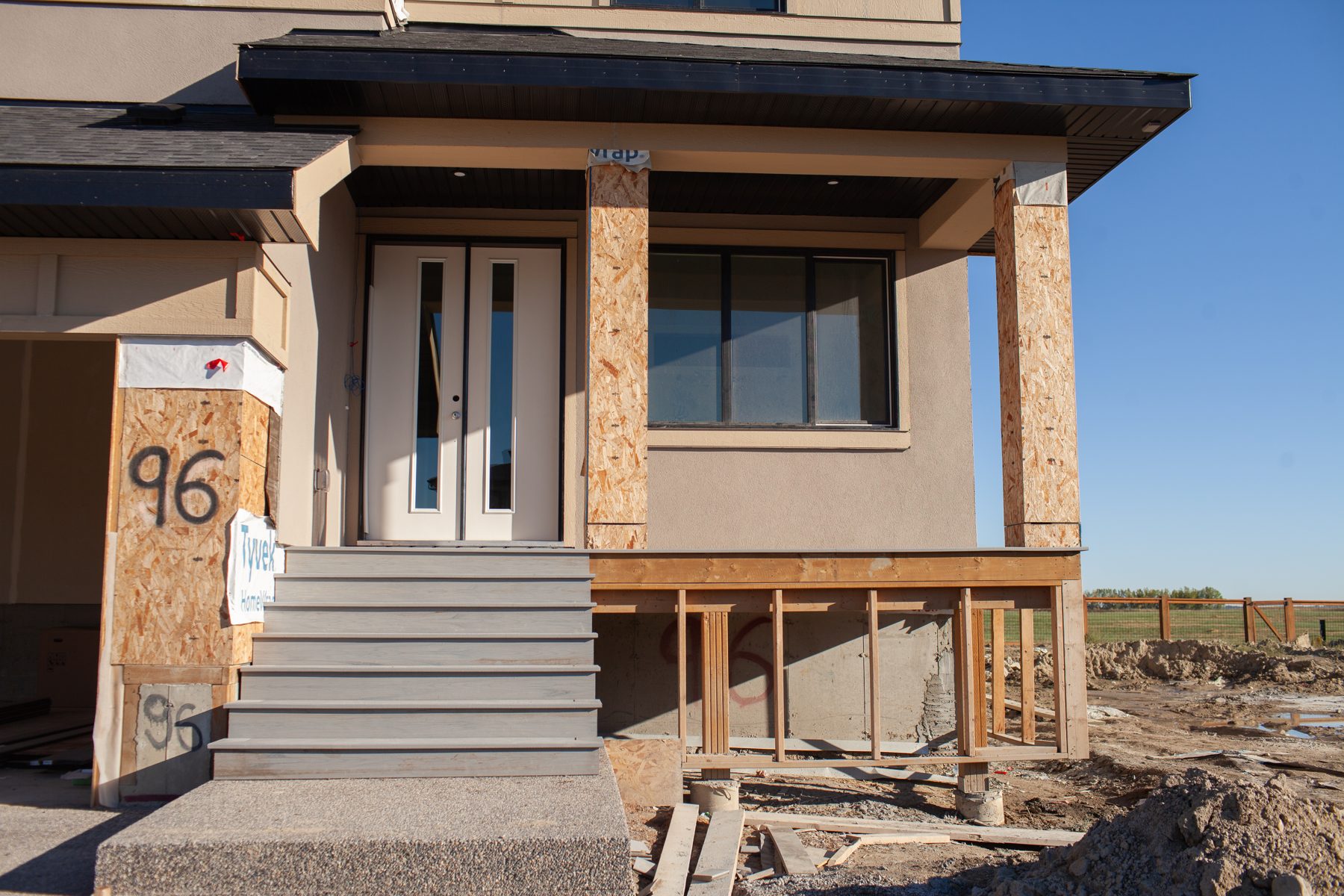 New house construction with unfinished porch and exterior framing — 96 Fieldstone Close