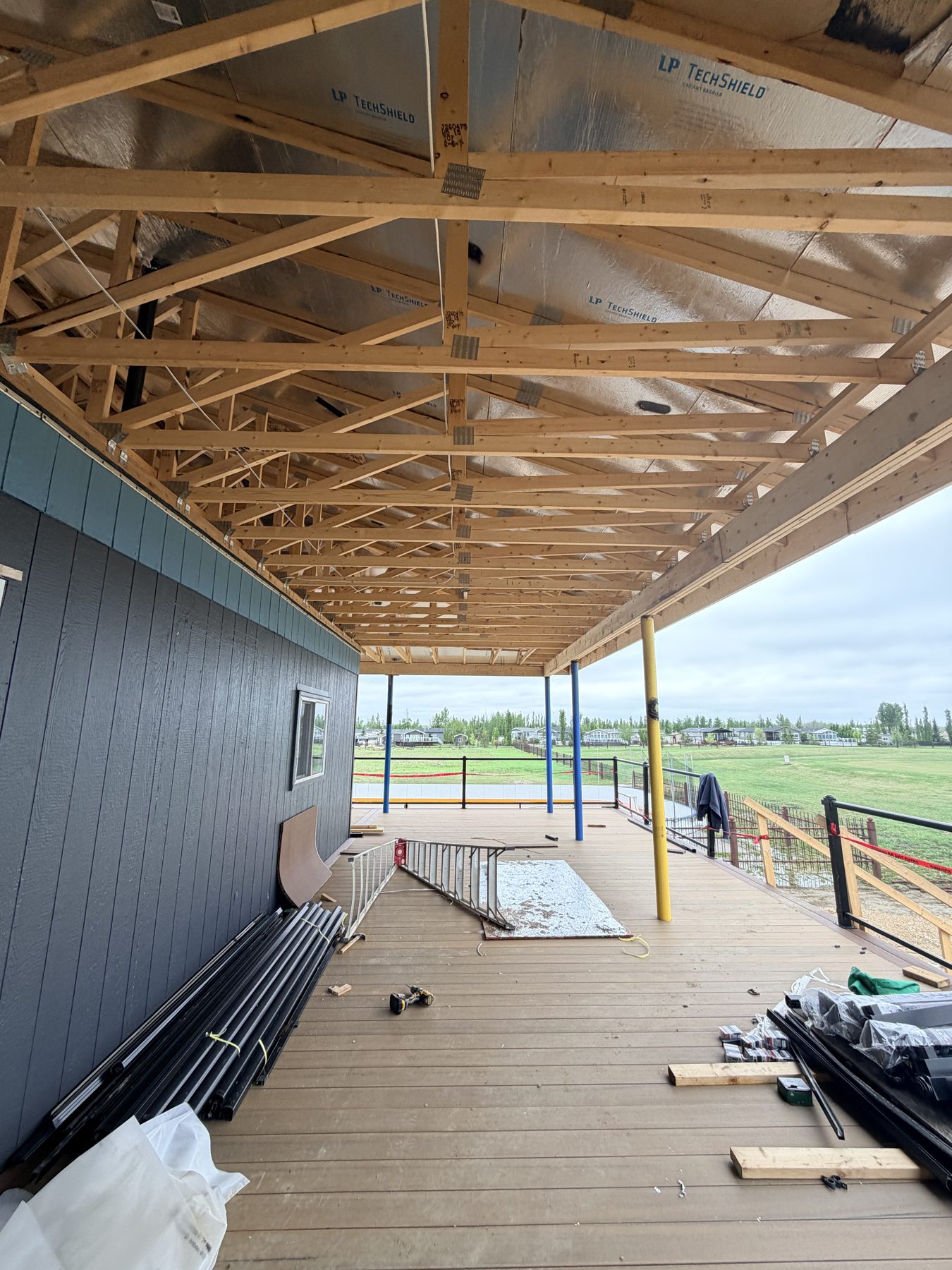 Construction framing for porch roof with siding and deck materials — Sandy Point (Club House)