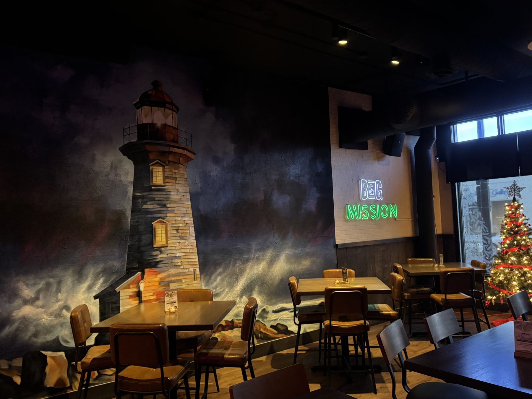 Dining room with lighthouse mural, tables, chairs, and a Christmas tree — Blowers and Grafton (Mission)