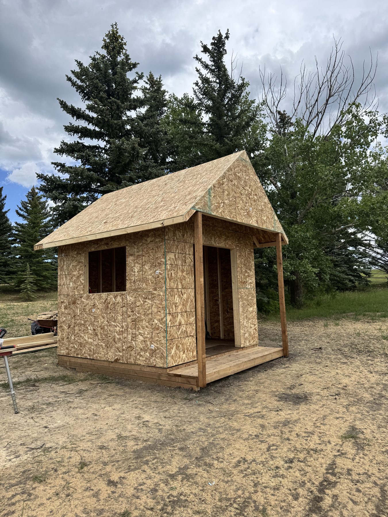Small structure with OSB walls and plywood roof under construction — 101 Lariat Loop, Calgary