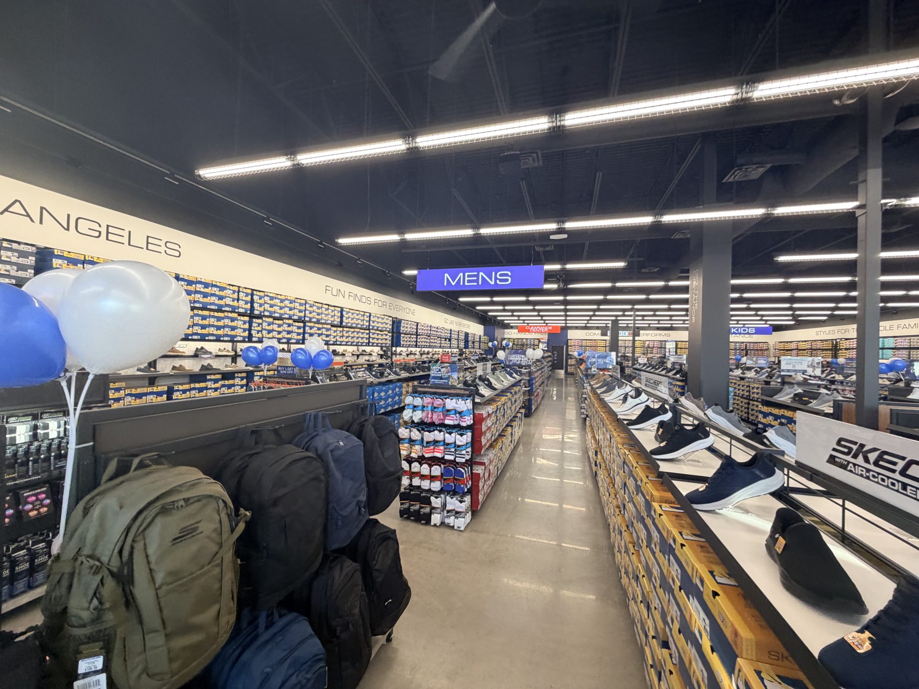 Shoe store interior with shelves of shoes, backpacks, and balloons — Skechers (Signal Hill)