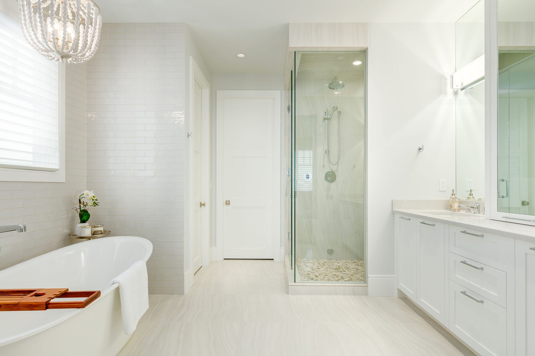 White subway tile bathroom with freestanding tub and glass shower — Cleret Velour