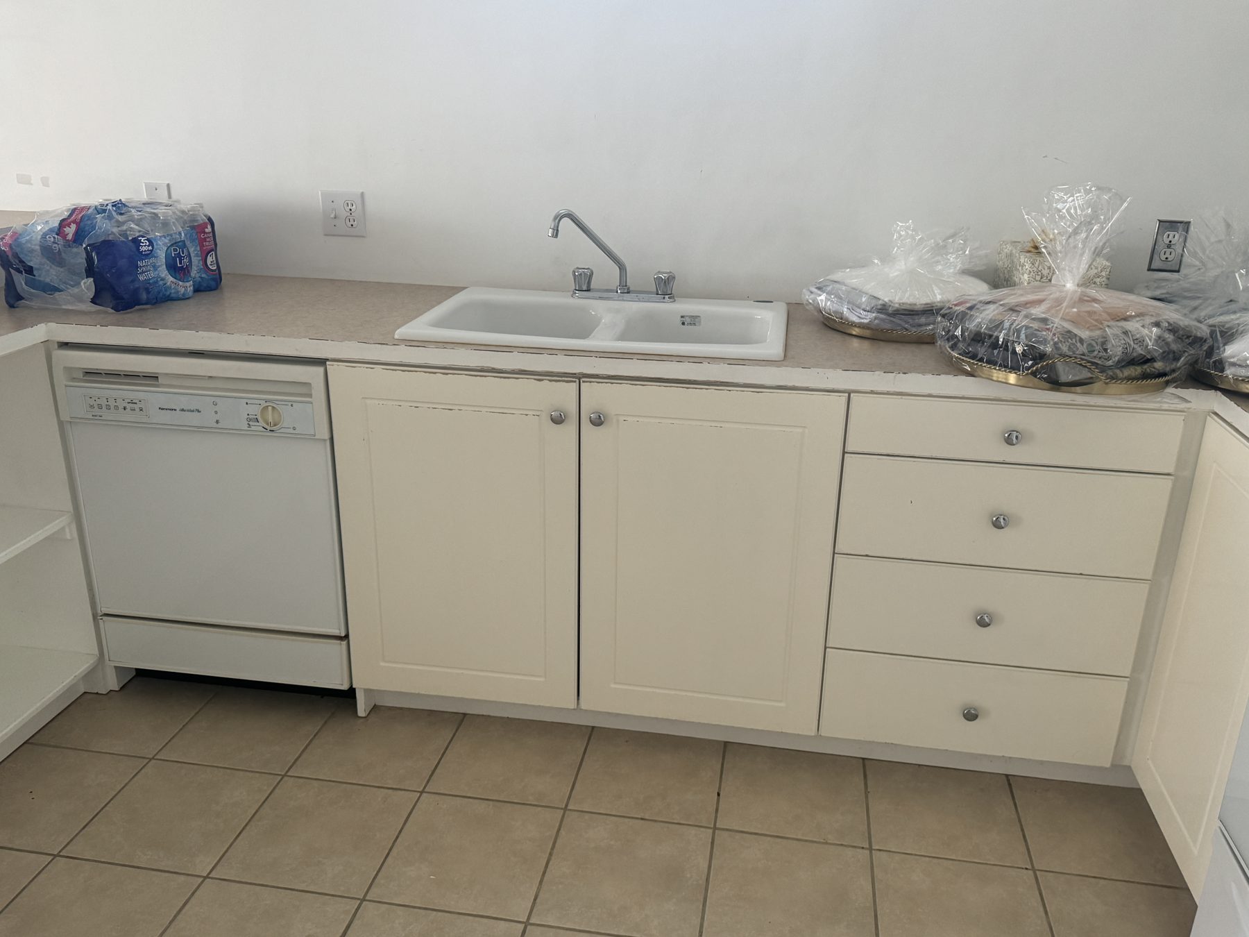 Kitchen renovation with new cabinets, sink, and appliances, ready for finishing touches — 14 Lochend Drive, Cochrane