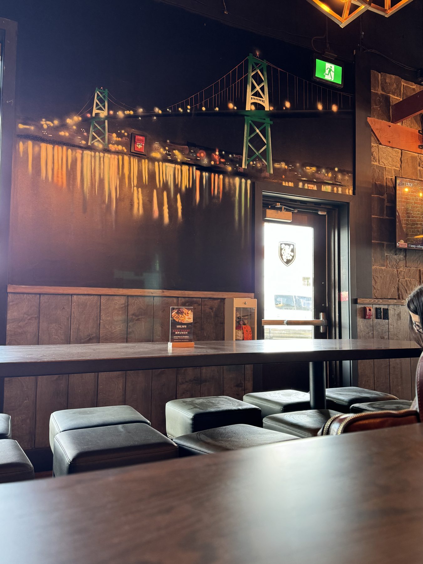 Bar interior with bridge mural, booths, and exit sign — Blowers and Grafton (Medicine Hat)