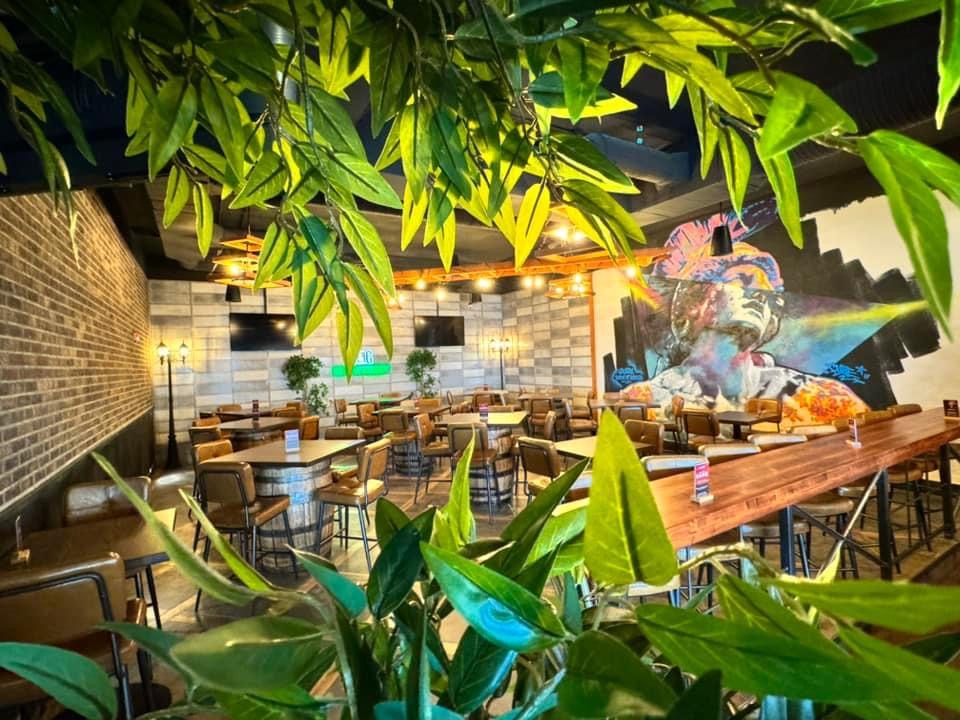 Modern restaurant interior with brick walls, graffiti, and barrel tables — Blowers and Grafton (Shawnessy)