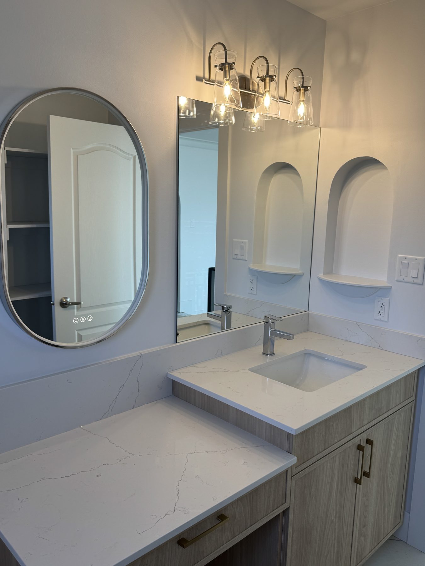 Modern bathroom vanity with white quartz countertops and wood cabinets — 14 Lochend Drive, Cochrane