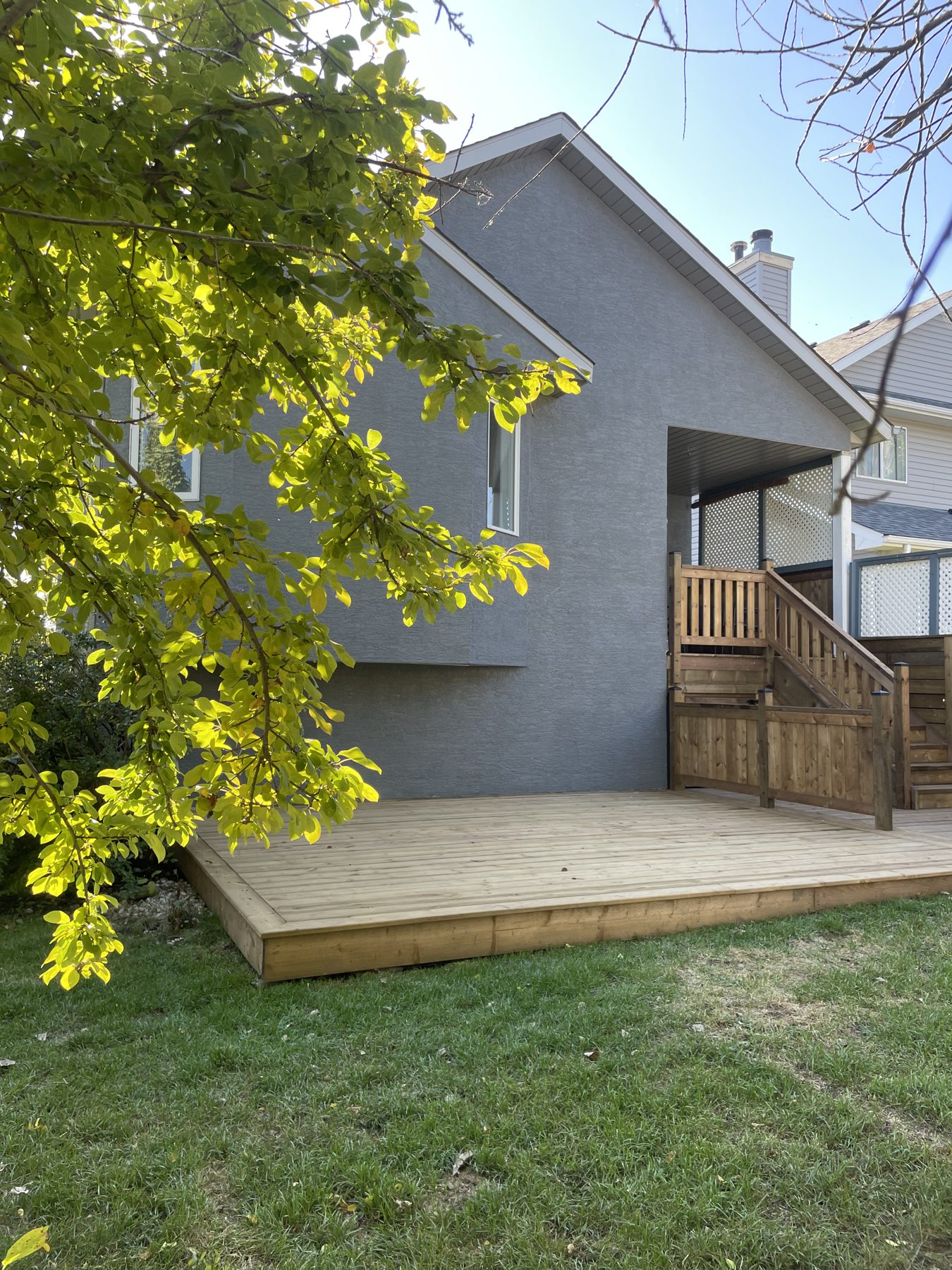 Newly constructed wooden deck and stairs leading to covered porch — 32 Somercrest Manor SW