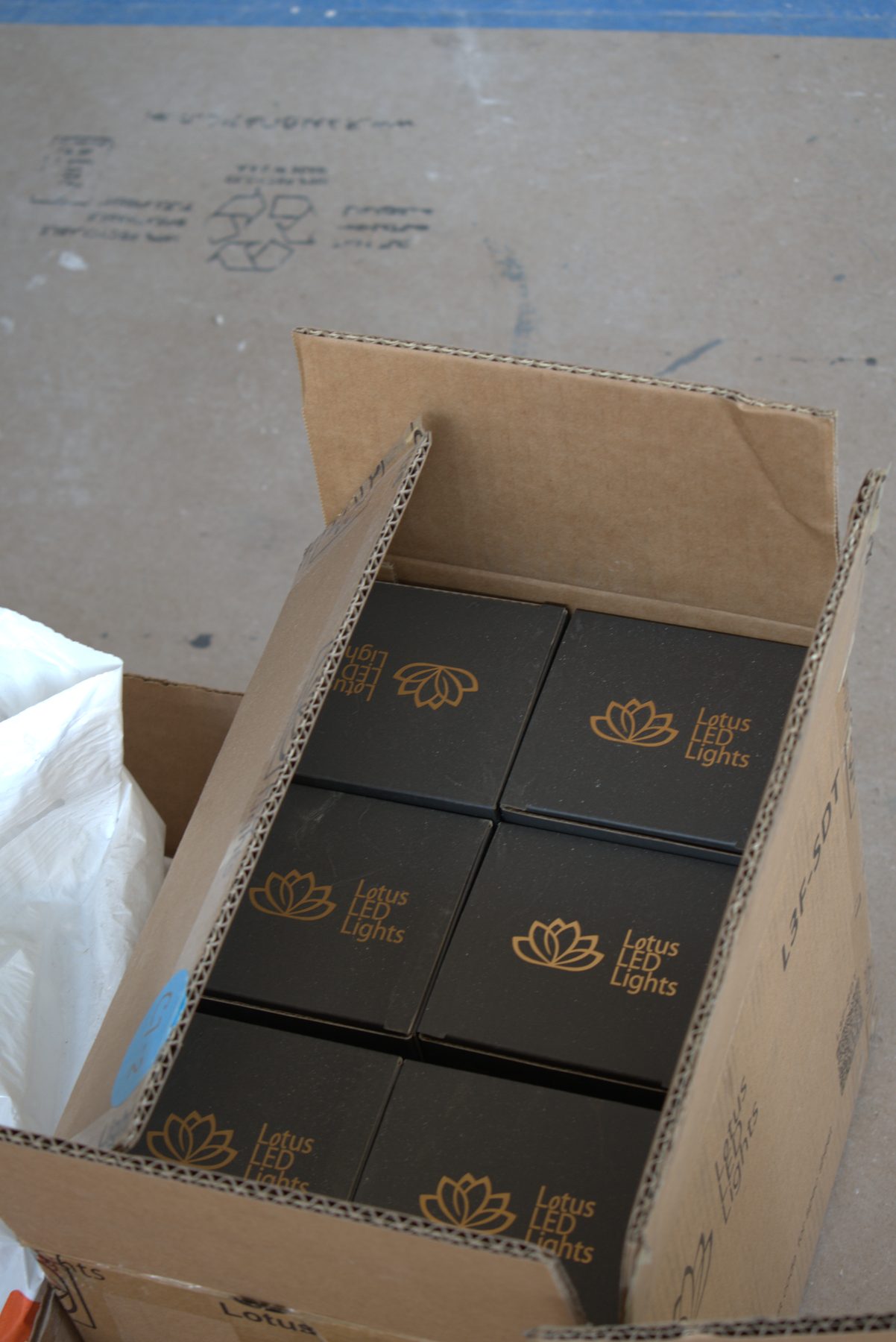 Cardboard box with several small black boxes of LED lights — ONE8T (West District)