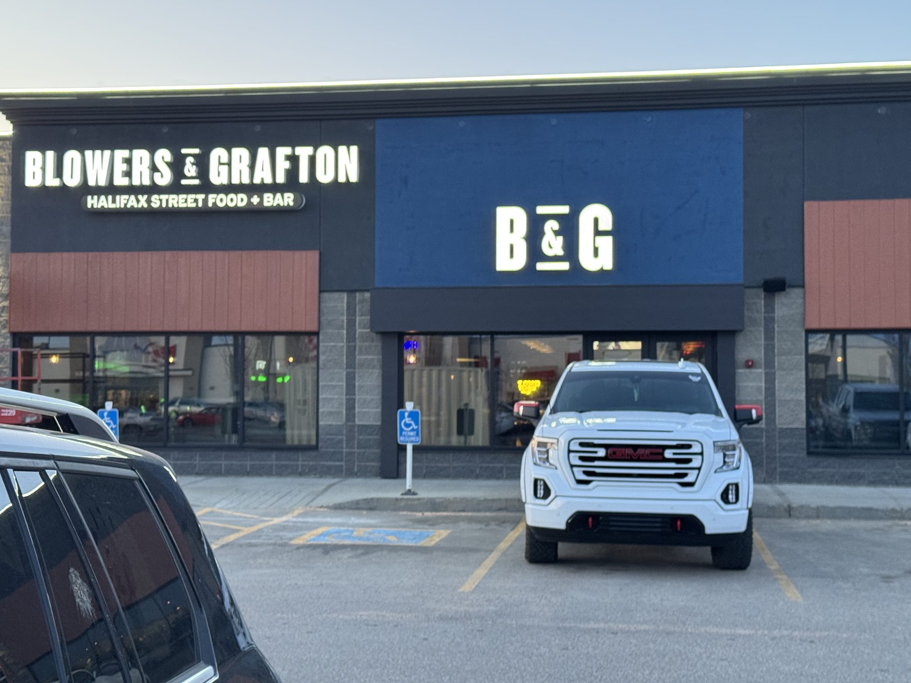 New restaurant exterior signage with red siding and blue accents — Blowers and Grafton (Lloydminster)