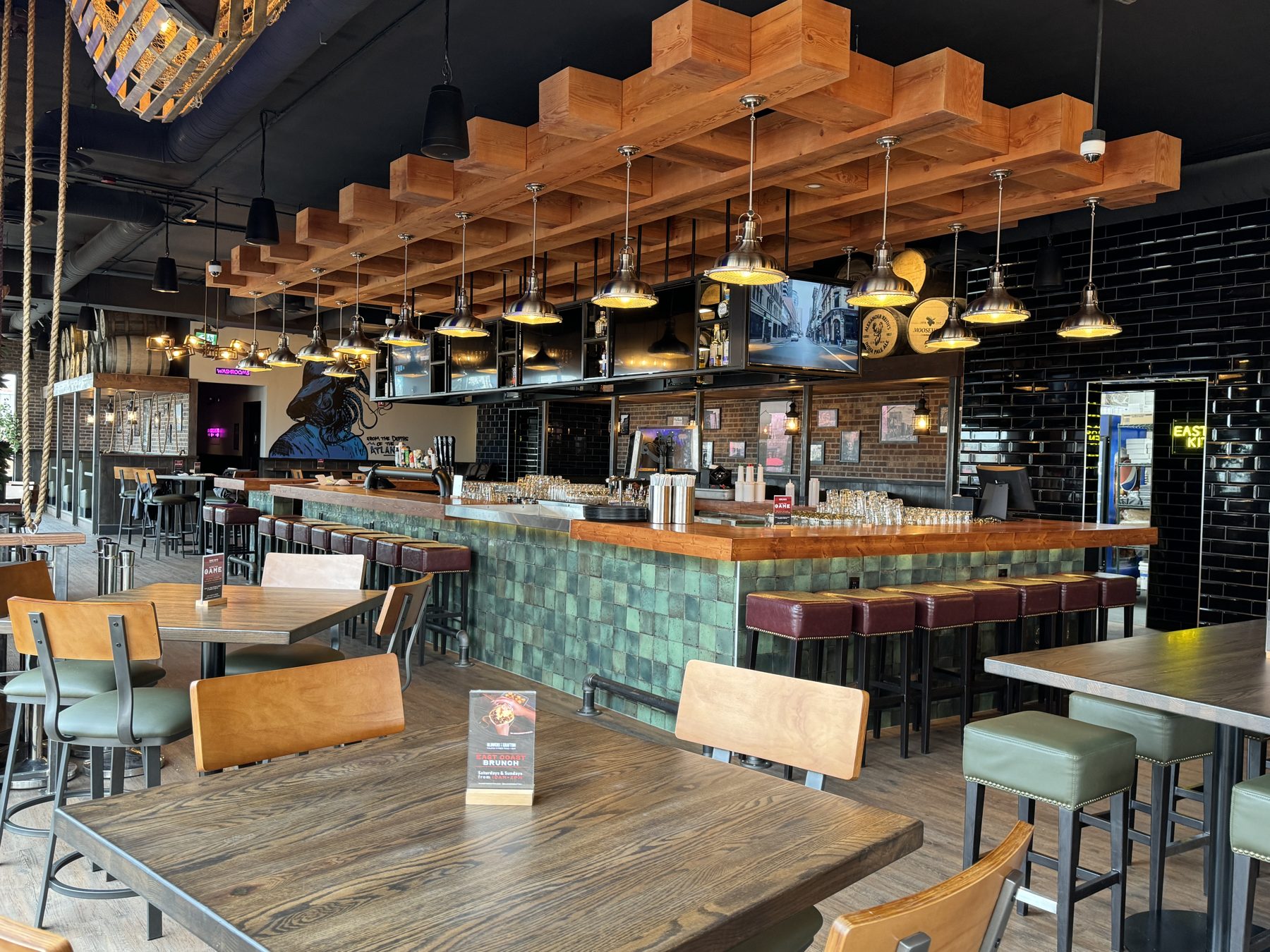 Restaurant bar with wooden ceiling beams, green tiled bar, and leather stools — Blowers and Grafton (Shawnessy)