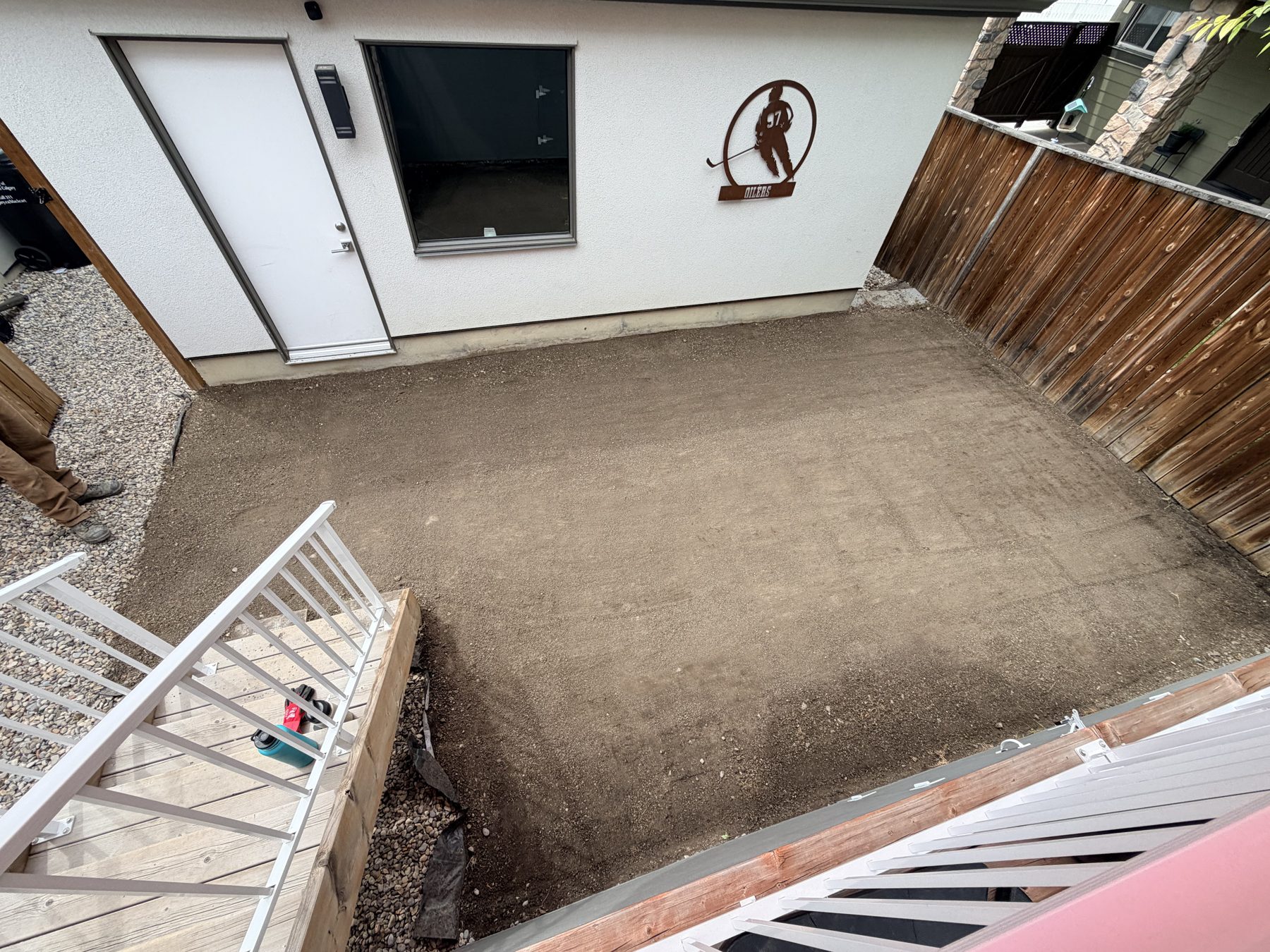 New gravel patio being installed next to a white building — 3505 41 Street SW, Calgary