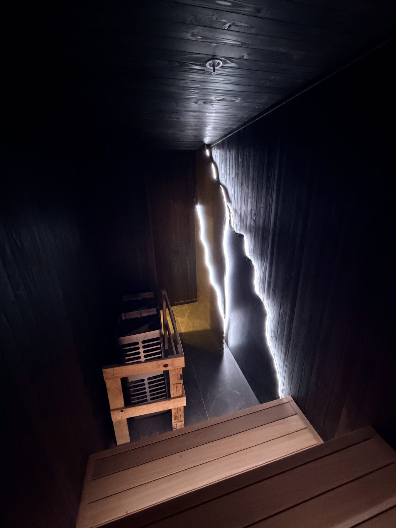 Wooden sauna with benches, heater, and decorative lighting installed — Cedar Steam and Spa (Trinity Hills)
