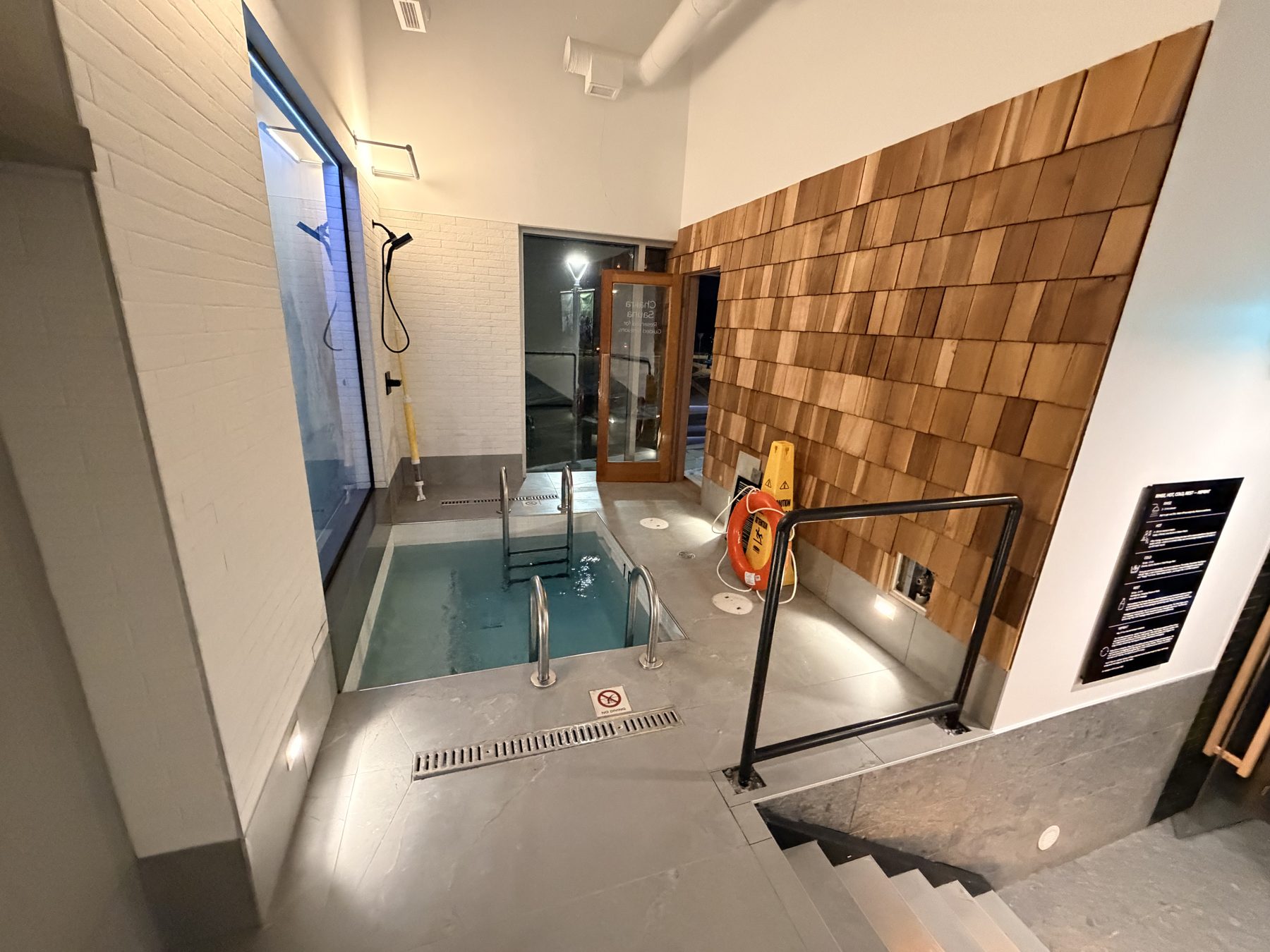 Modern indoor plunge pool with wood accent wall and shower — Cedar Steam and Spa (Trinity Hills)