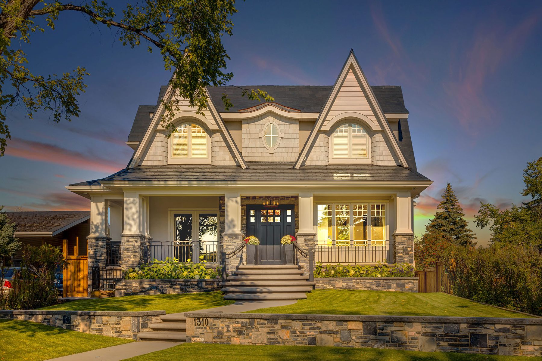 Renovated house with stone accents and new front porch landscaping — White House by Onsite Contracting Services