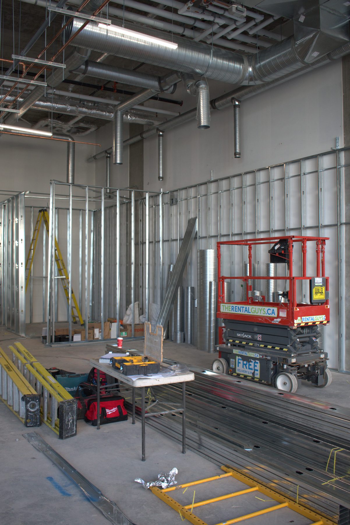 Interior construction: metal framing, ducts, and scissor lift — Leela Spa (West District)