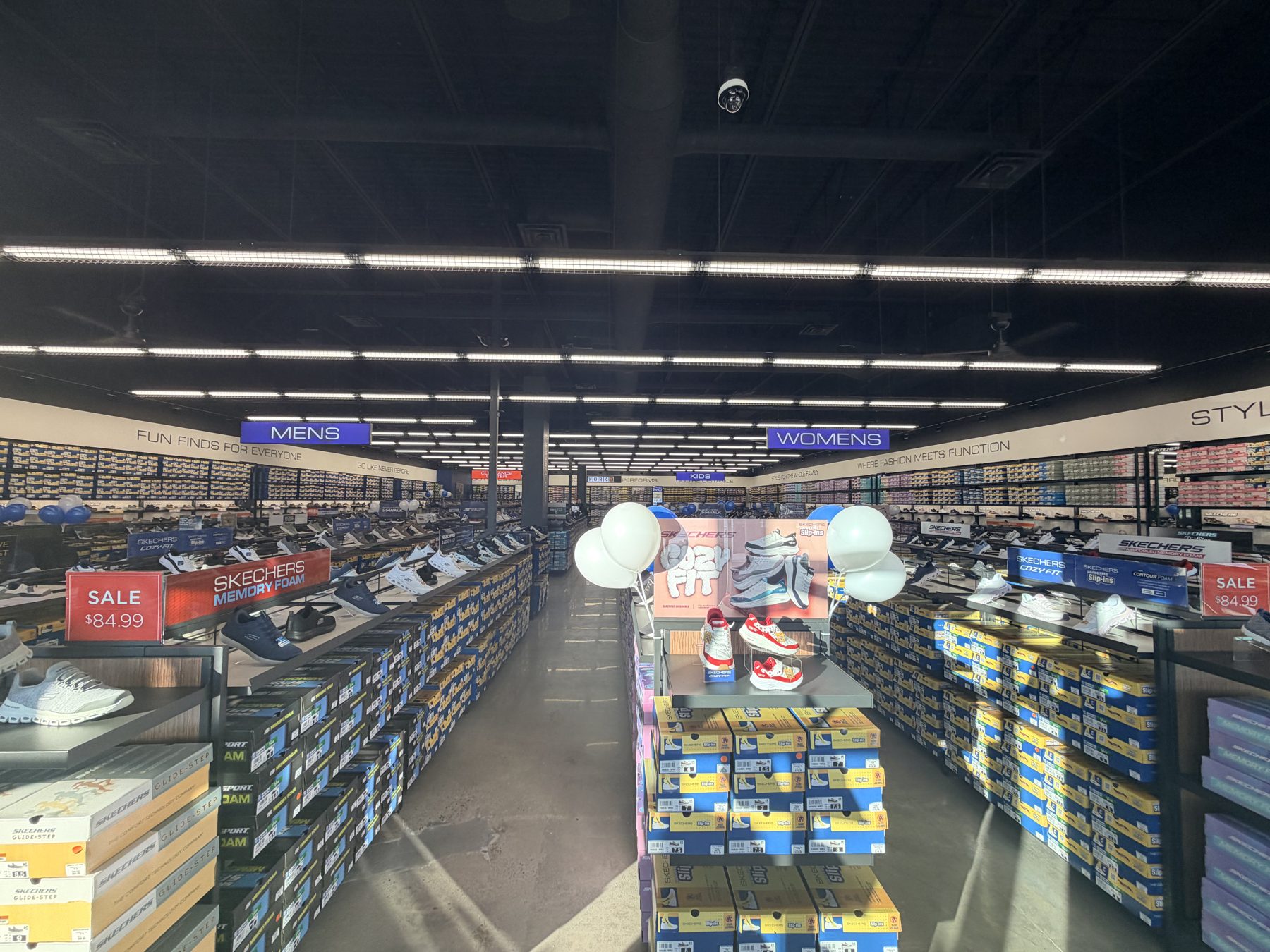 Shoe store interior showing aisles stocked with shoes and boxes — Skechers (Signal Hill)