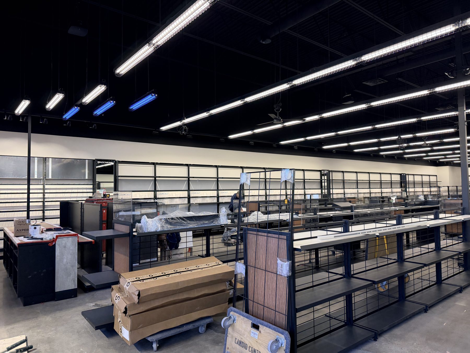 Retail space under construction with new shelving and checkout counters — Skechers (Signal Hill)