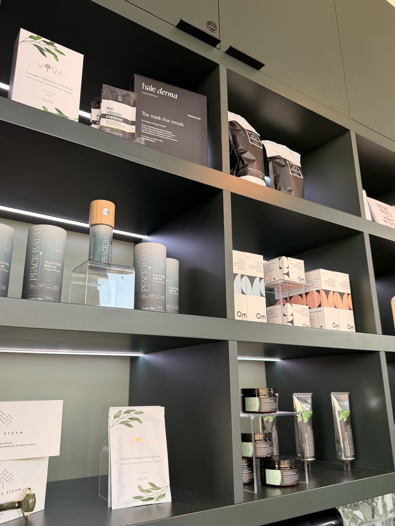Shelving unit displaying skincare products, including masks and roll-ons — Cedar Steam and Spa (Trinity Hills)