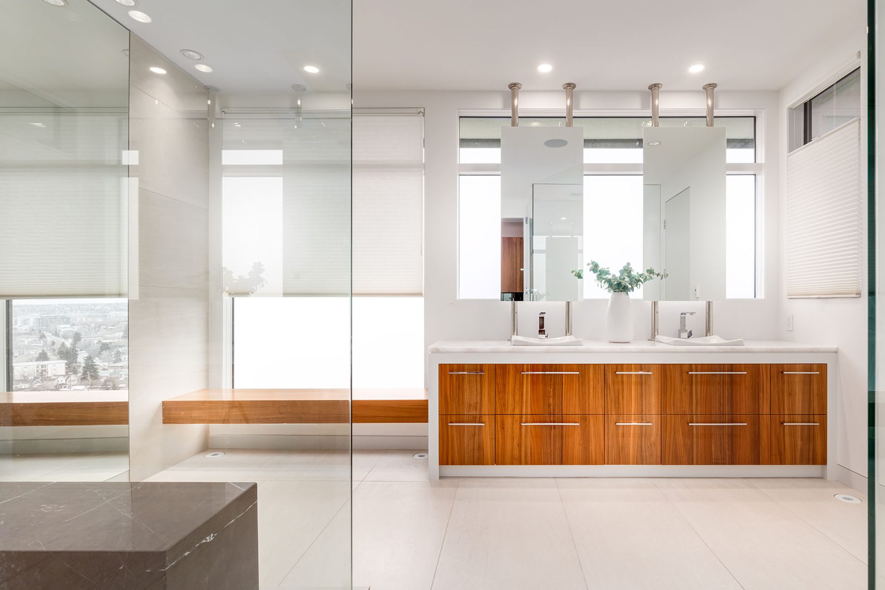Modern bathroom with double vanity, glass shower, and wood bench — Timeless Form
