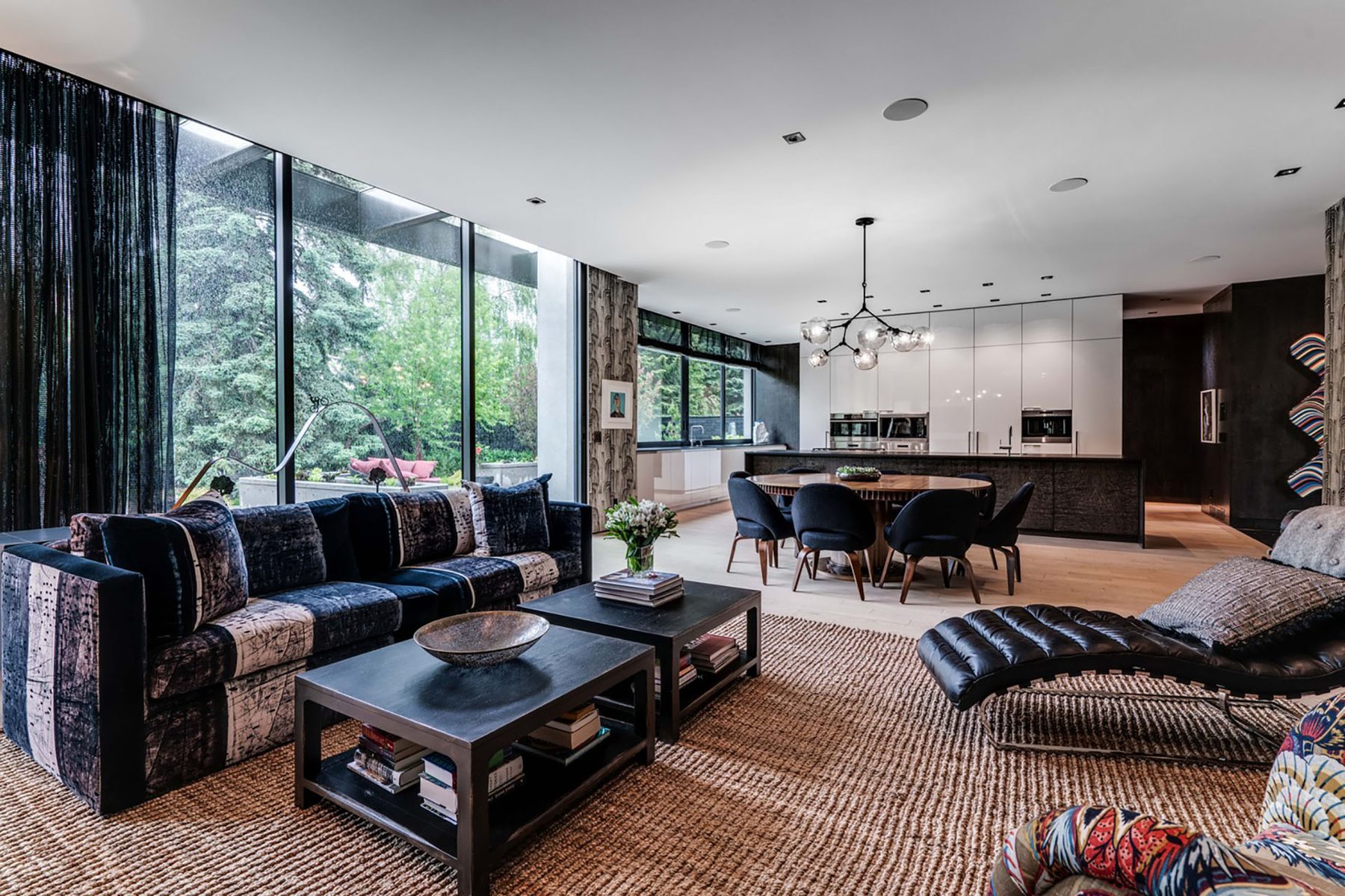 Living room and kitchen featuring modern furnishings and large windows — Modern Family