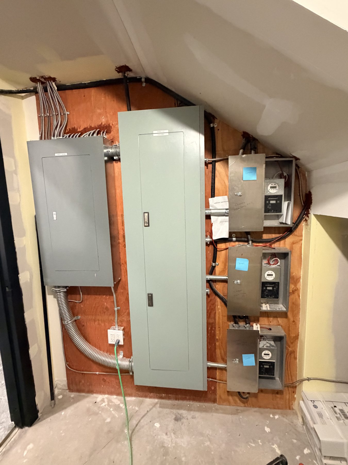 Electrical panels and meters are installed on a wood-paneled wall — Cedar Steam and Spa (Trinity Hills)