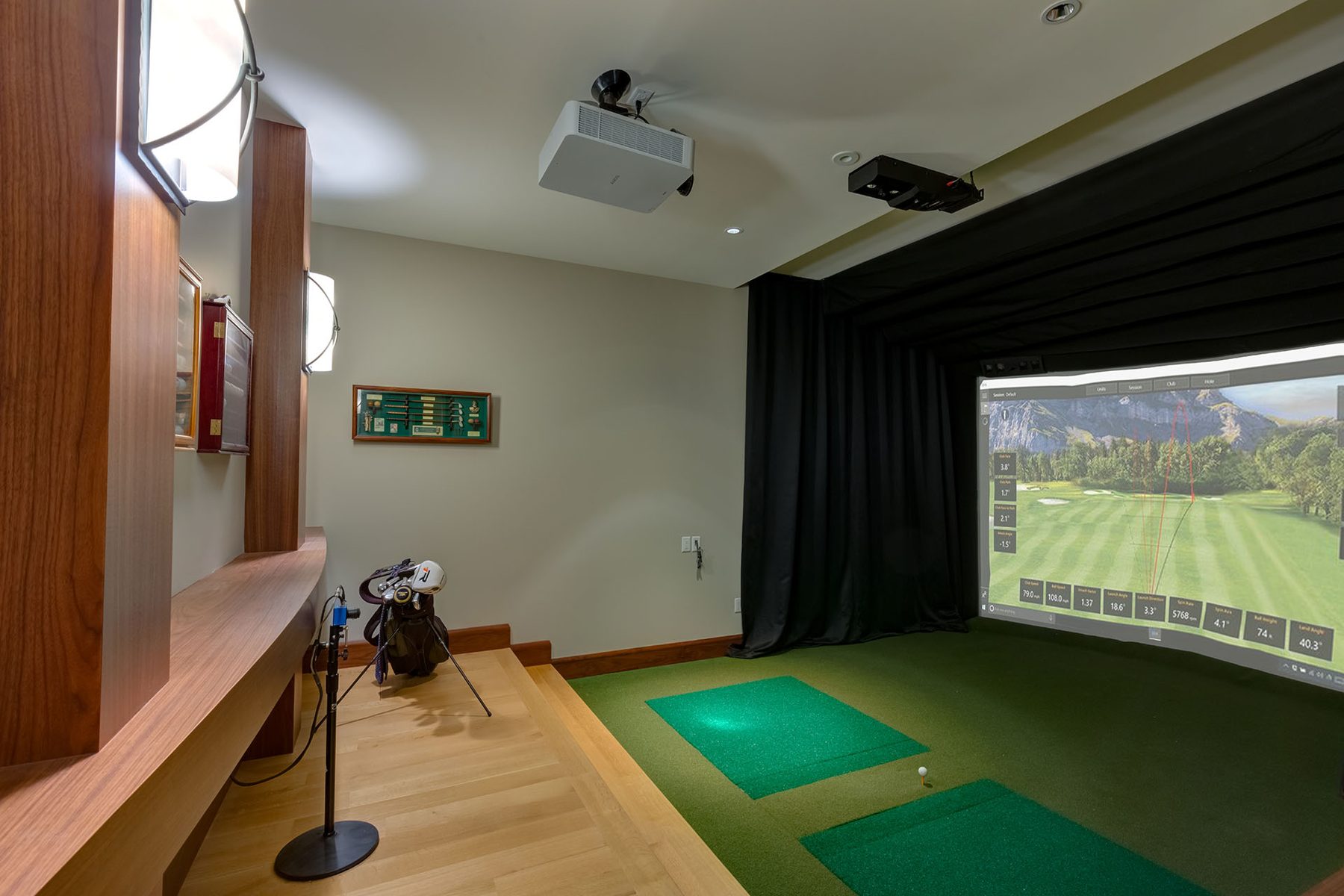 Indoor golf simulator room with projector, screen, and turf — Oxford